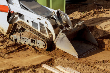 Mini bulldozer with earth doing landscaping works