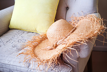 woman's strawhat on the sofa
