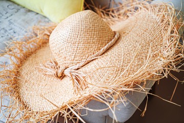 woman's strawhat on the sofa