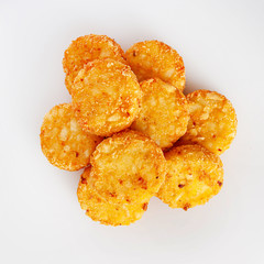 Pile of cooked potato hash browns isolated on a white background