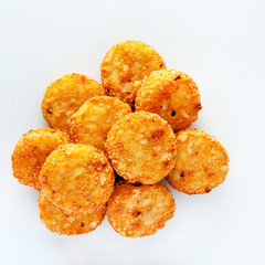 Pile of cooked potato hash browns isolated on a white background