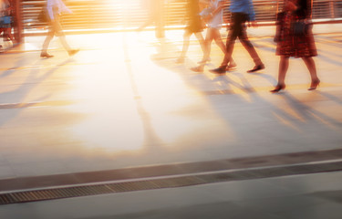 People are walking with sunset.