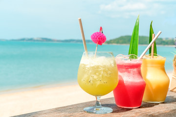 Colorful mocktails at the beach bar with sea background. Vacation, get away, summer outing concept