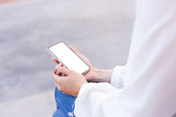 cell phone Mockup image blank white screen.woman hand holding texting using mobile on desk at coffee shop.background empty space for advertise text.people contact marketing business,technology