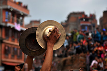 Guy playing traditional musical instrument at festival at bhaktapur, nepal
