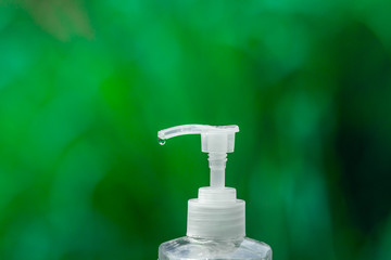 Fototapeta na wymiar alcohol gel for hand wash on green background 