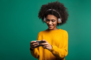 Woman listening music play games by smartphone.