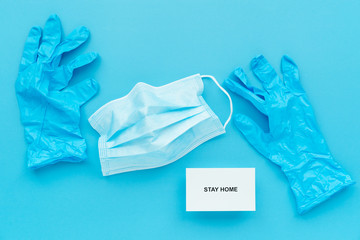 stay home and healthy to prevent covid-19 spread campaign, text on paper with doctor blue gloves and mask