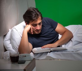 Obraz premium Young handsome man suffering from insomnia at home