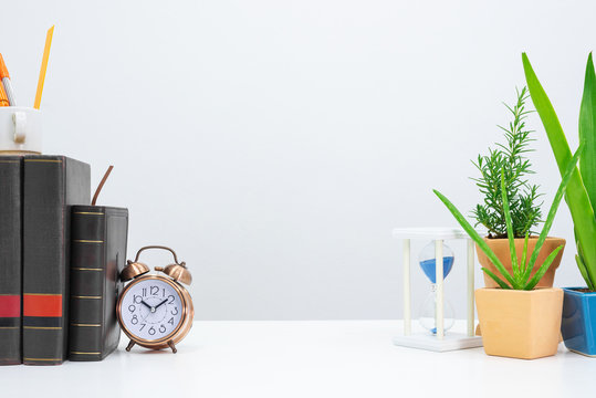 Mock up timeglass, book , clock, agave, aloe vera and book on desk table.