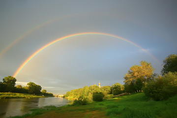 Naklejka premium summer landscape with a rainbow