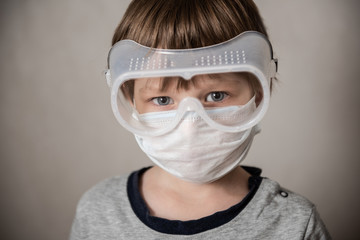 Boy in medical mask. Coronavirus COVID-19 lockdown, panic. Vaccine from new virus. Negative emotions