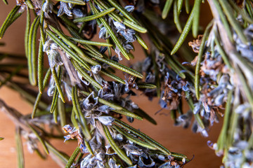 Fresh rosemary herb with flowers on wooden table. Top view rosemary macro