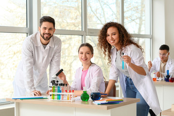 Young people at chemistry lesson in classroom
