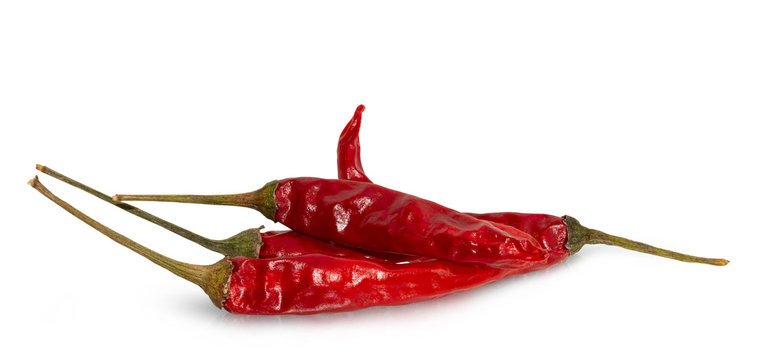 Dried red hot peppers isolated on white.