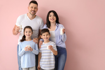 Family drinking milk on color background