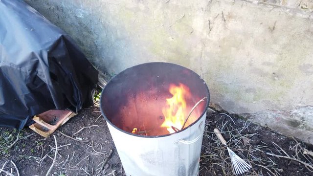 A shot of a garden incinerator burning garden waste.