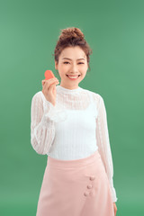 Portrait Of Asian Girl Isolated Holding a Paper Heart Over Green Background
