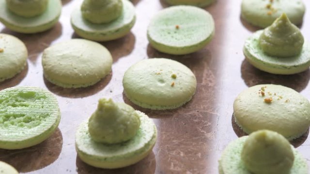 French Macarons making process. Filling cream. Confectioner making dessert. Step by step
