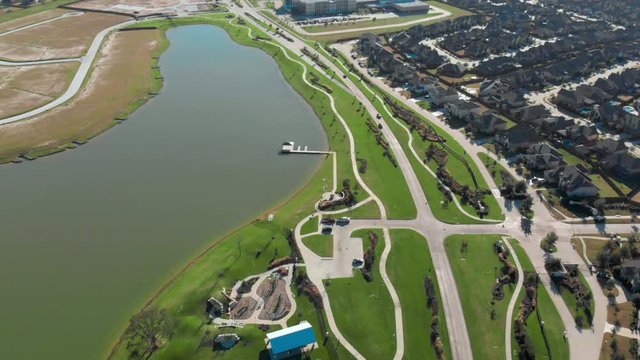 Aerial Establishing shot of a luxurious neighborhood. Aerial shot of a quiet neighborhood next a beautiful lake. New in construction subdivision in Houston Texas. Wide Shot, drone footage