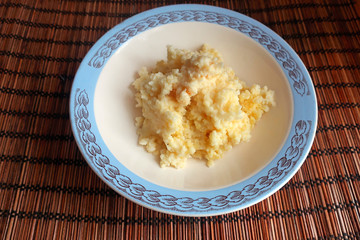 millet porridge cooked in milk for breakfast in a plate on the table