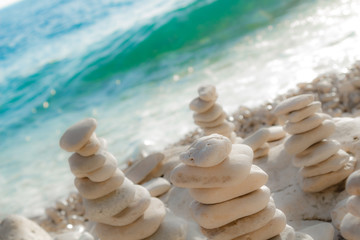 Fototapeta na wymiar Zen stones on the beach - summertime and good vibes.