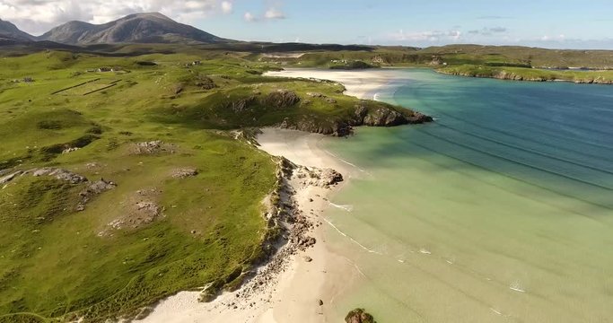 Waves rolling into the empty, white sand beaches of Uig Bay of the Isle of Lewis in the Outer Hebrides Islands of Scotland.
