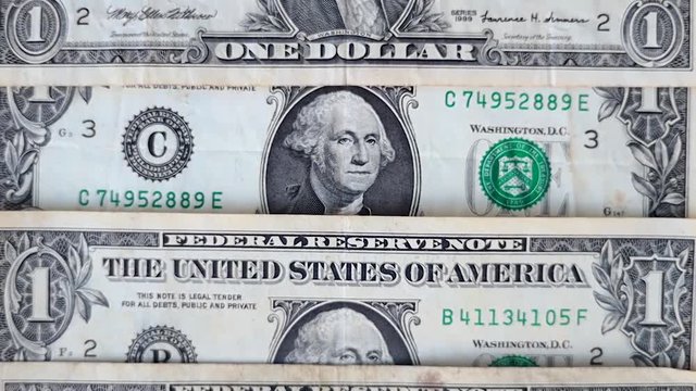 One dollar bills stacked on top of each other. United Stated Dollar