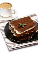 Classic tiramisu dessert on ceramic plate and cup of coffee isolated on white background with clipping path