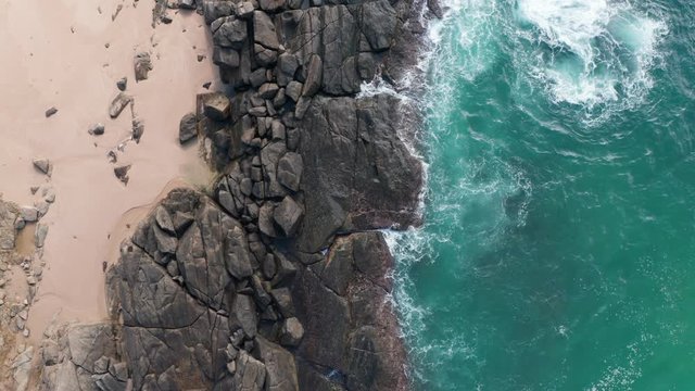 Aerial: Drone Sri Lanka Rocks devide the sea and sand