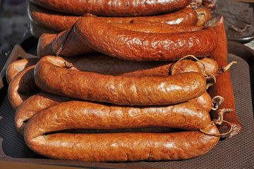 Closeup of  pork sausages for sale on farmers market. Smoked sausage. Traditional natural sausage, homely sausage as food background