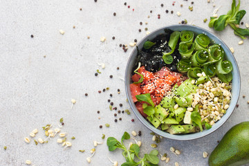 Poke bowl with smoked salmon, cucumber, avocado, sea kale, bean sprouts, sesame and herbs. Grey...