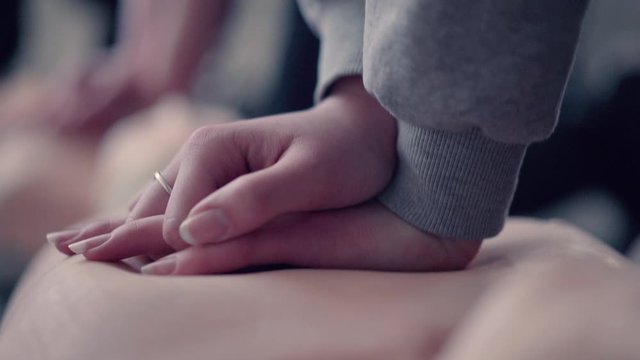 Female hands, performing cpr at emergency training.