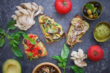 Bruschetta on a dark background, Assorted bruschetta, Top view, Italian toasted crusty ciabatta bread