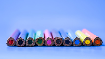 Crayons Colored pencils background. Color pencils on blue background. Close up. Copy space