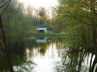 Forest lake in the south of France, view on a chalet