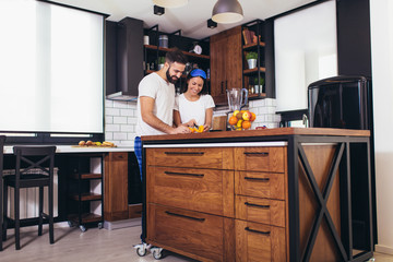 Couple making fresh organic juice in kitchen together