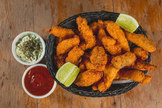 Comida de boteco brasileira frango frito isca fli&eacute; servido em tigela em balc&atilde;o de boteco