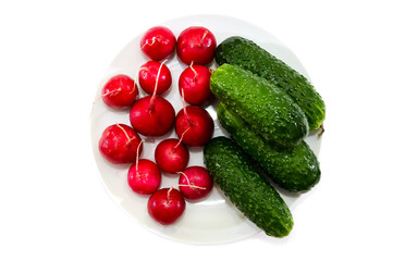 radishes and cucumbers in a plate on a white background.