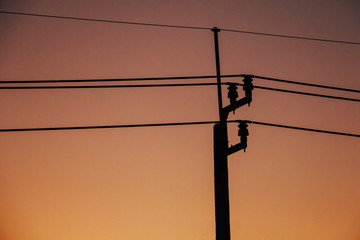 Silhouette electric pole and sunset, Beautiful red sunset sky behind electric poles.
