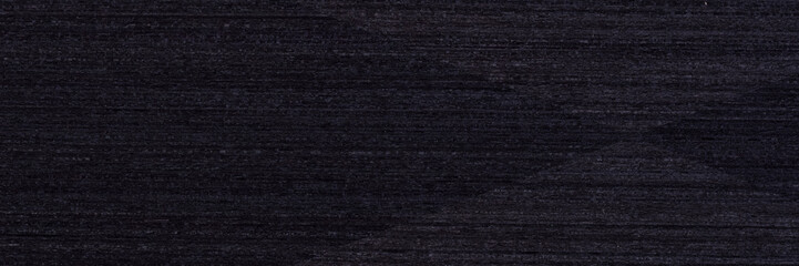 Stylish black veneer background as part of your strict design. Long plank texture. Wooden pattern.