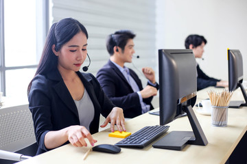 Asia Group of call center workers or Confident business team with headset in office.