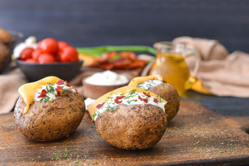 Tasty baked potato with sour cream on table