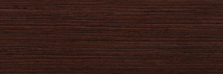 Obraz na płótnie Canvas Veneer background in dark brown color for your new design view. Natural wood texture, pattern of a long veneer sheet.