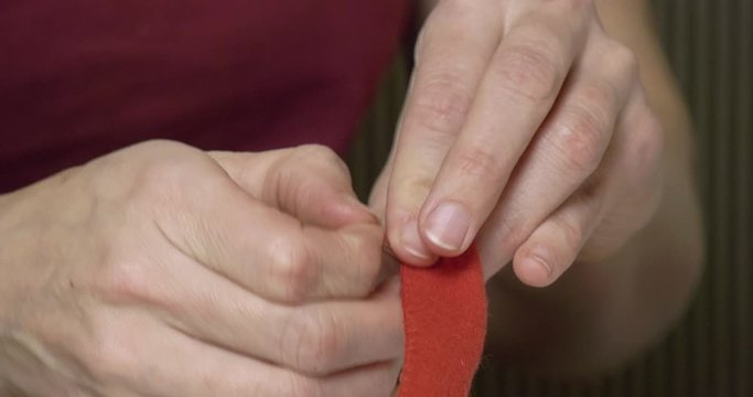 Close-up of the seamstress's hand for the fine work of making a toy. 