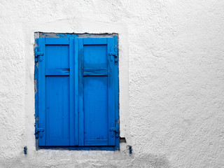 A blue shutter adorns a window in the Italian Dolomites