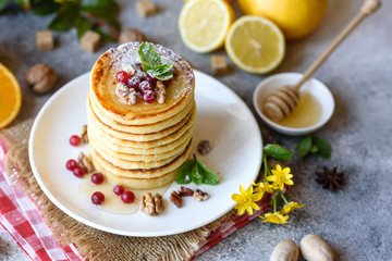 Delicious fresh beautiful pancakes with citrus honey and jam