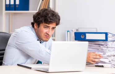 Overloaded busy employee with too much work and paperwork