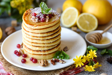 Delicious fresh beautiful pancakes with citrus honey and jam