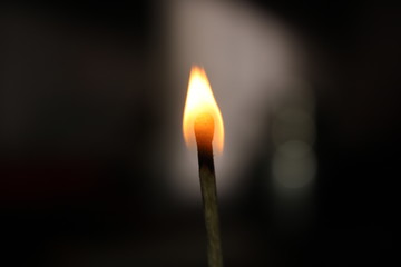 burning match on black background